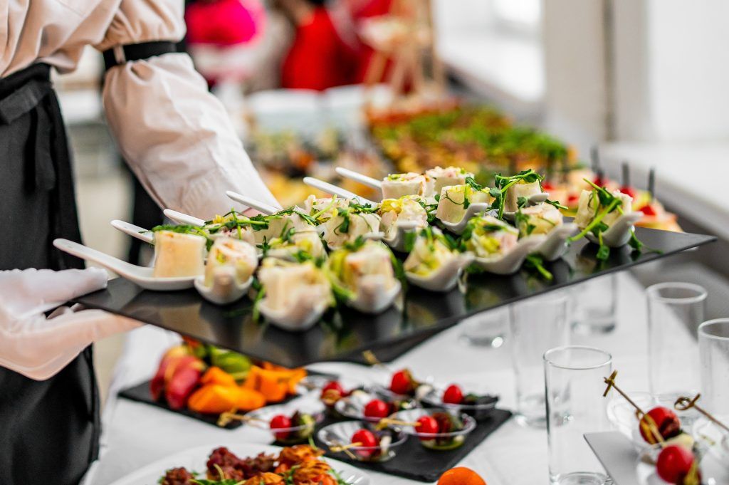 buffet bartender replenishing dish