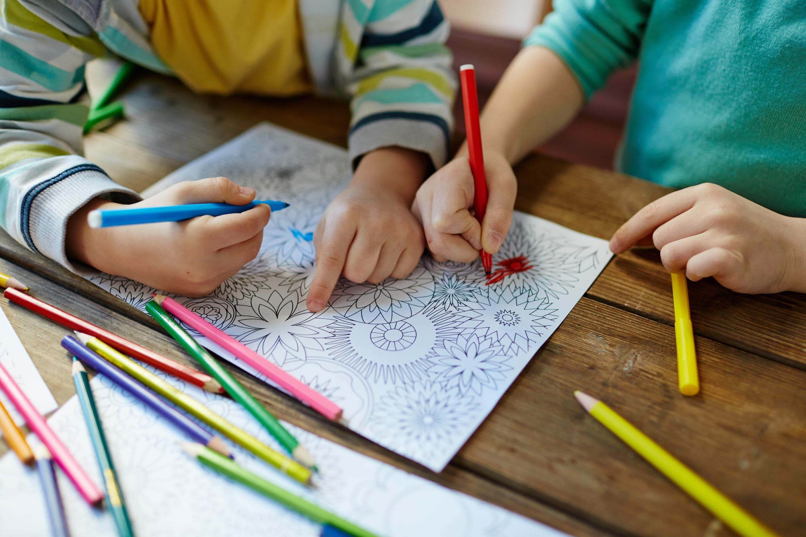 children coloring with colorful pencils