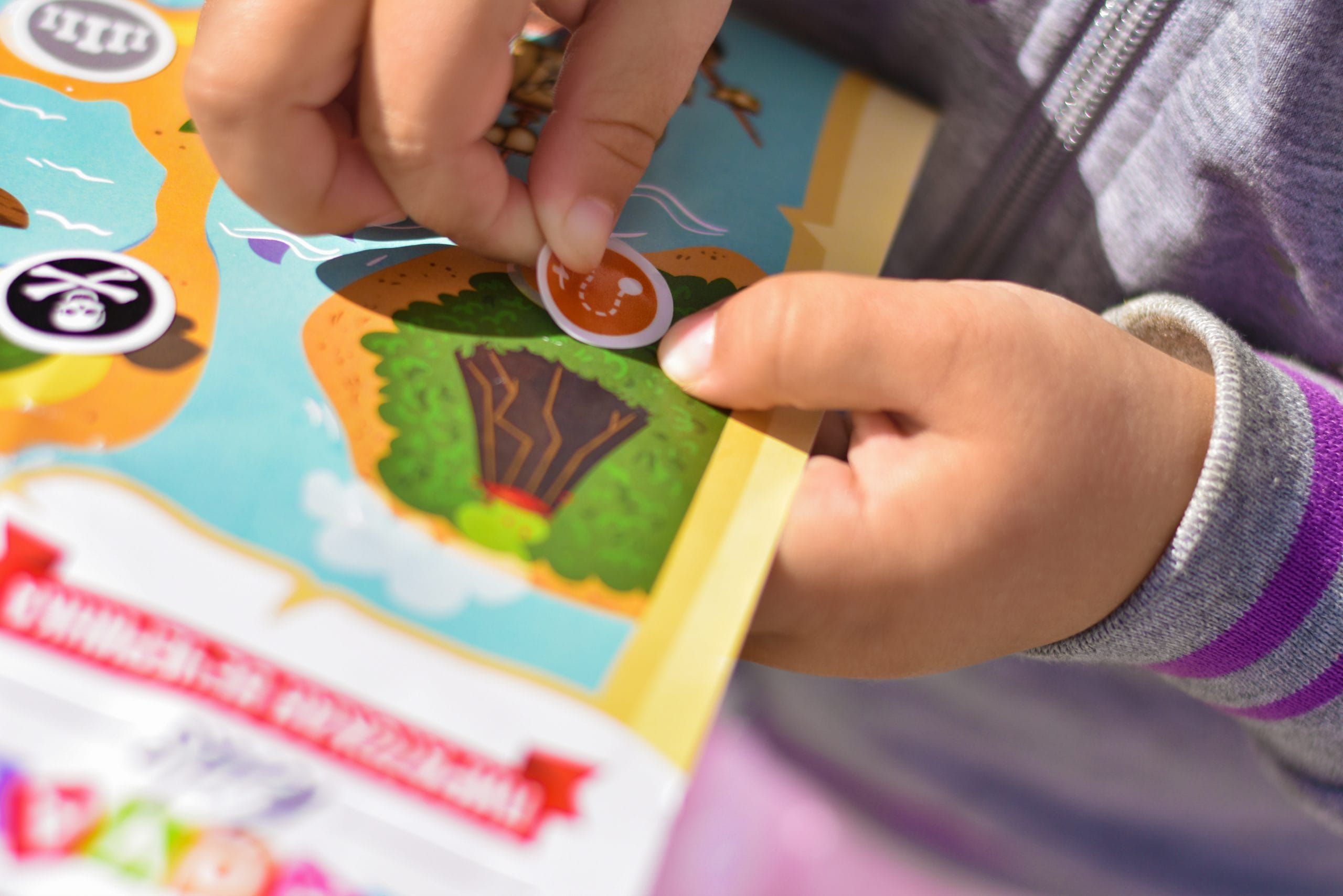 child sticking a sticker