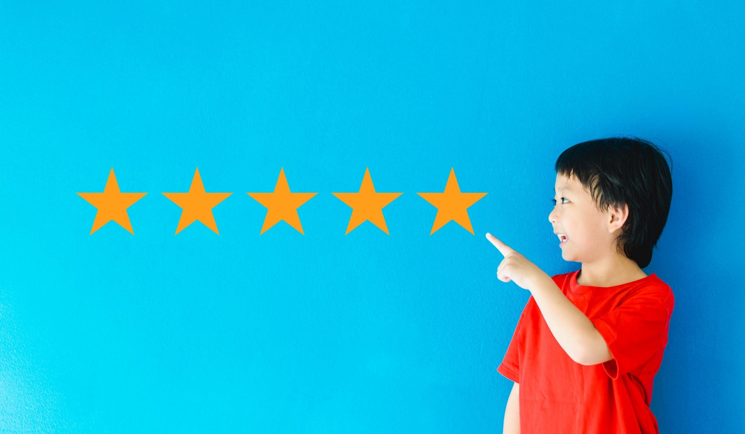 child pointing on five stars