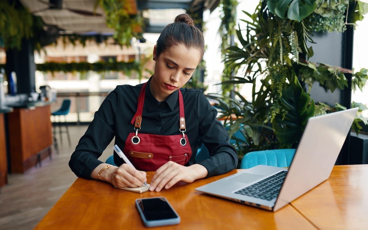 server writing down reservations