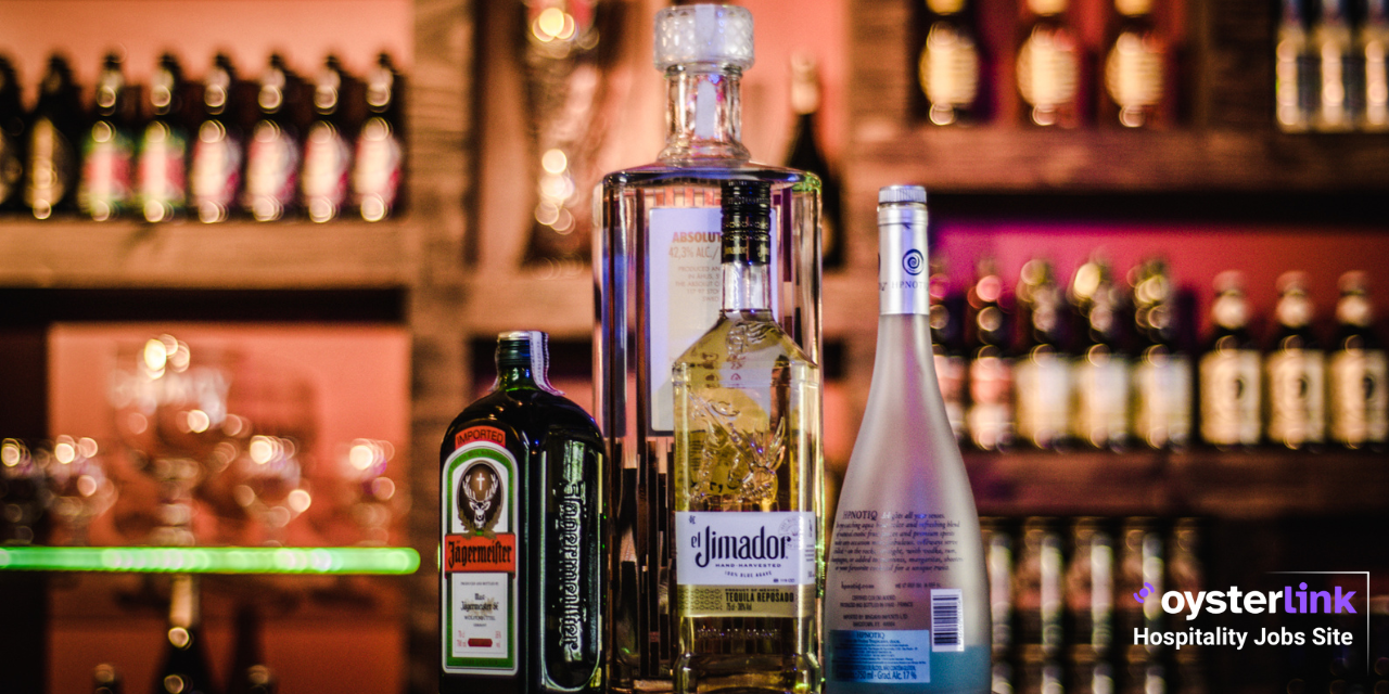Liquor bottles standing on a bar top