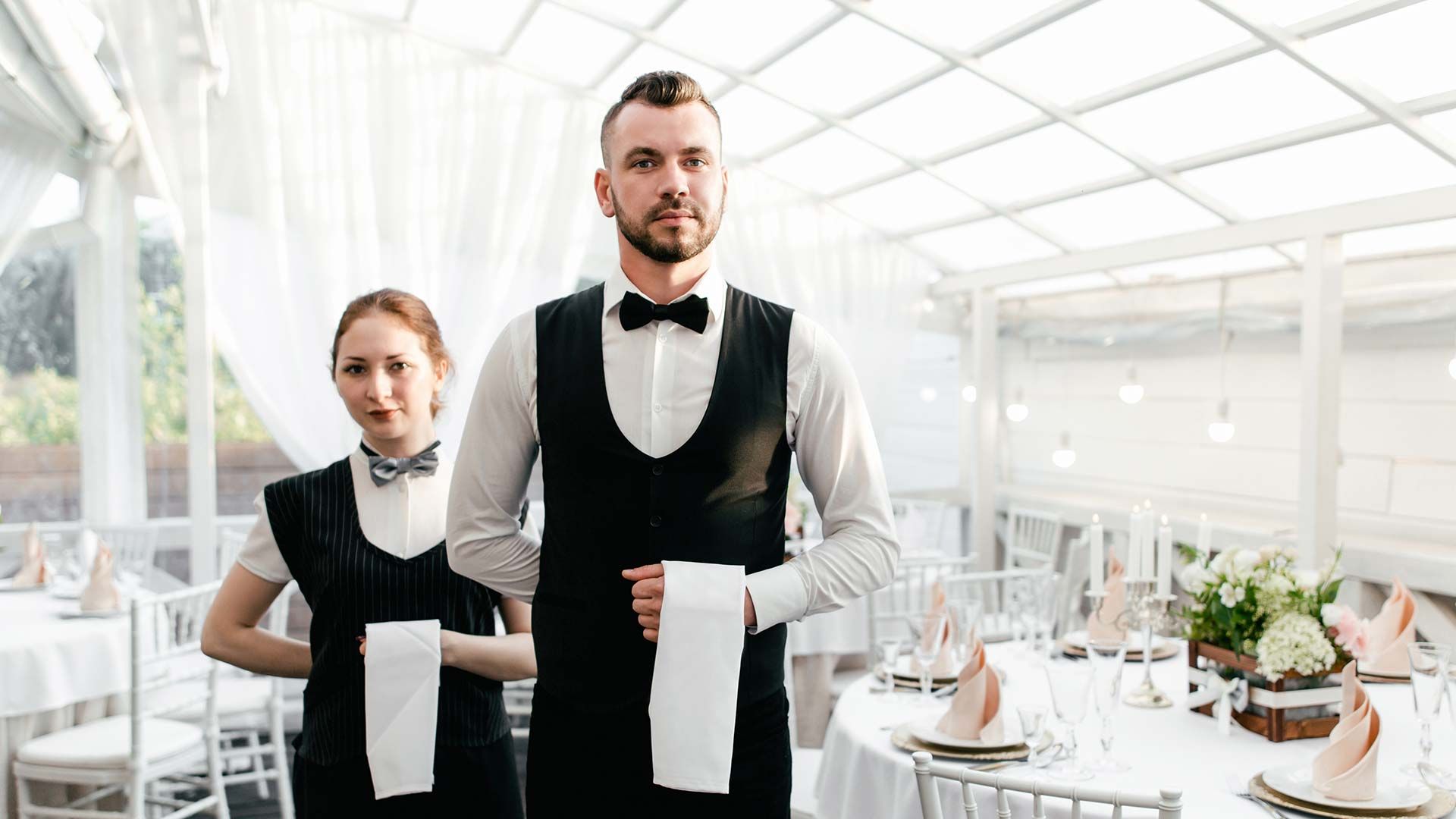 waiter and backwaiter waiting at table