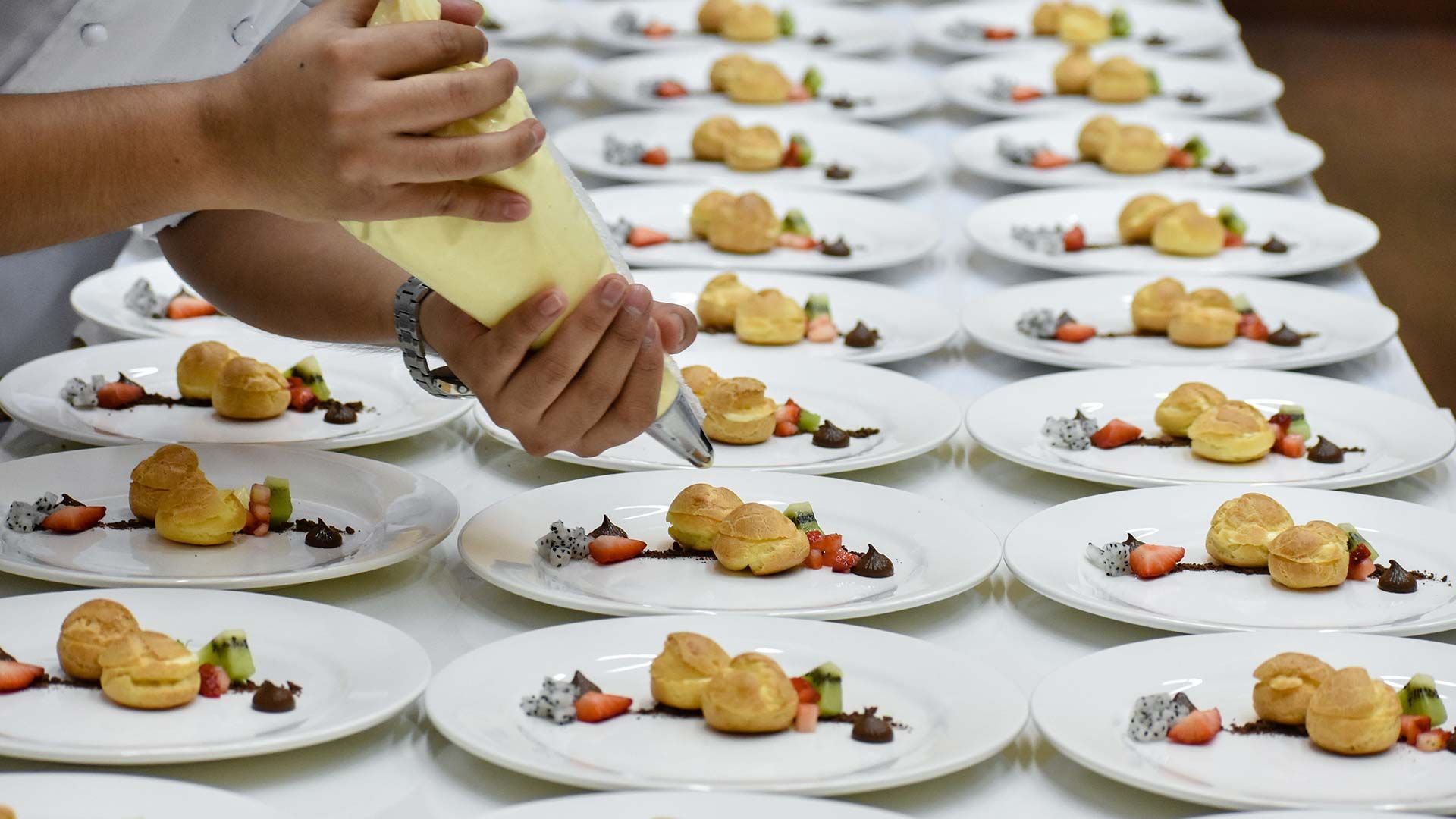 banquet chef garnishing plates
