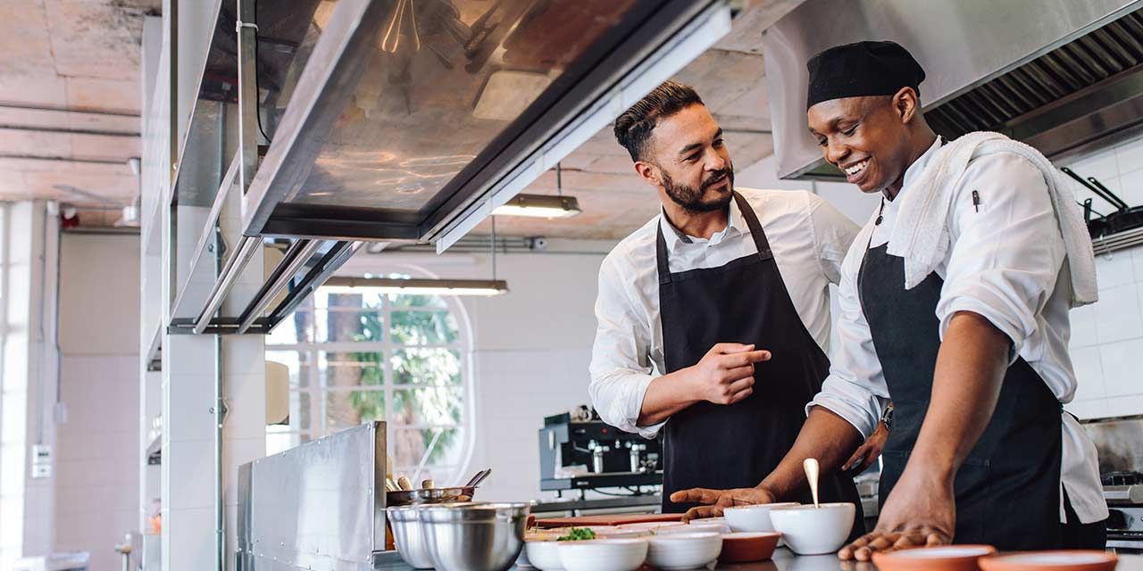 chefs in kitchen talking